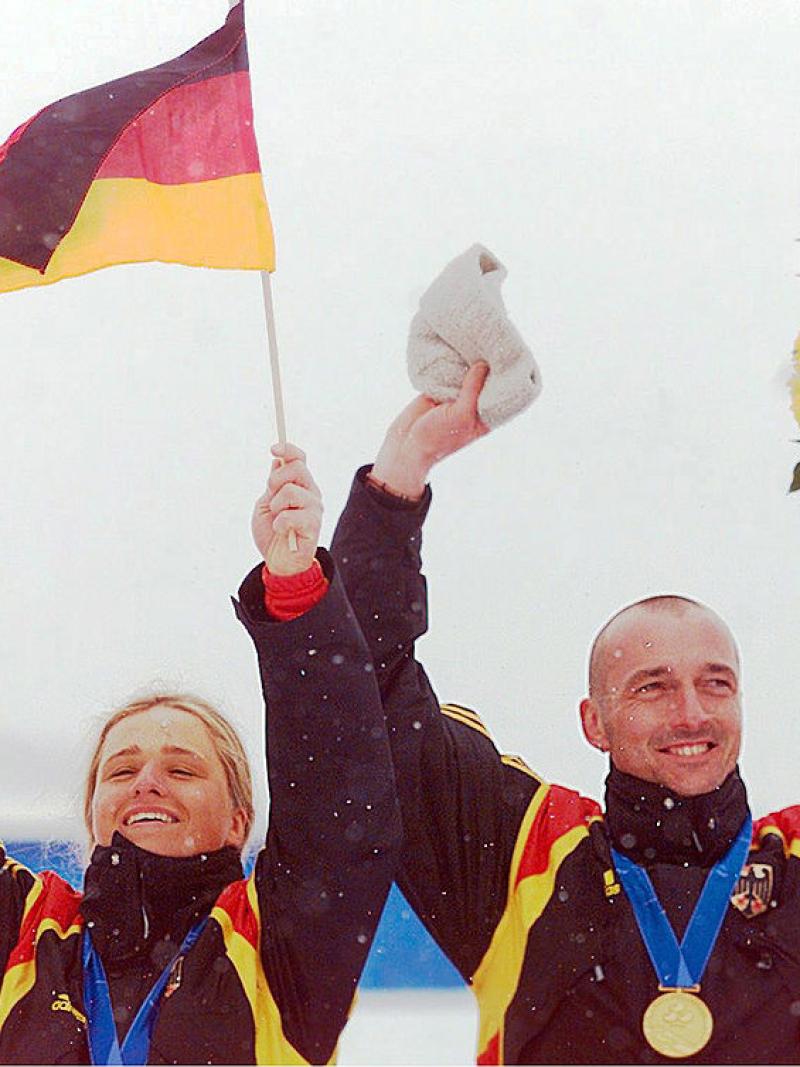 Verena Bentele celebrates on the podium with her guide at Salt Lake City 2002
